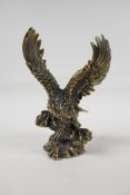 A filled bronze figure of an eagle, impressed Chinese four character mark to base, 8" high