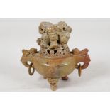 A Chinese carved soapstone Kors and cover, with two elephant head handles, the cover carved with a