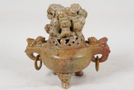 A Chinese carved soapstone Kors and cover, with two elephant head handles, the cover carved with a