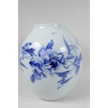 A Japanese porcelain vase decorated with stylised flowers in blue and red with character
