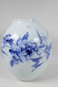 A Japanese porcelain vase decorated with stylised flowers in blue and red with character