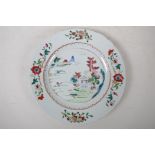 An C18th/C19th famille rose enamelled porcelain cabinet plate decorated with a riverside