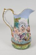 A Capodimonte style pottery jug embossed with Bacchanalian figures and painted in bright enamels,