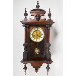 A mahogany Vienna Regulator wall clock with carved and turned column decoration, the movement