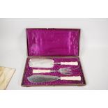 A boxed set of good quality silver plated fish servers and crumb scoop with hallmarked silver