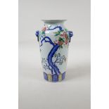 A Chinese polychrome porcelain vase with two mask handles and enamelled pomegranate tree decoration,