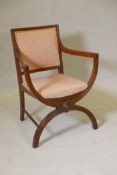 A C19th walnut elbow chair with reeded back and arms, raised on X shaped supports