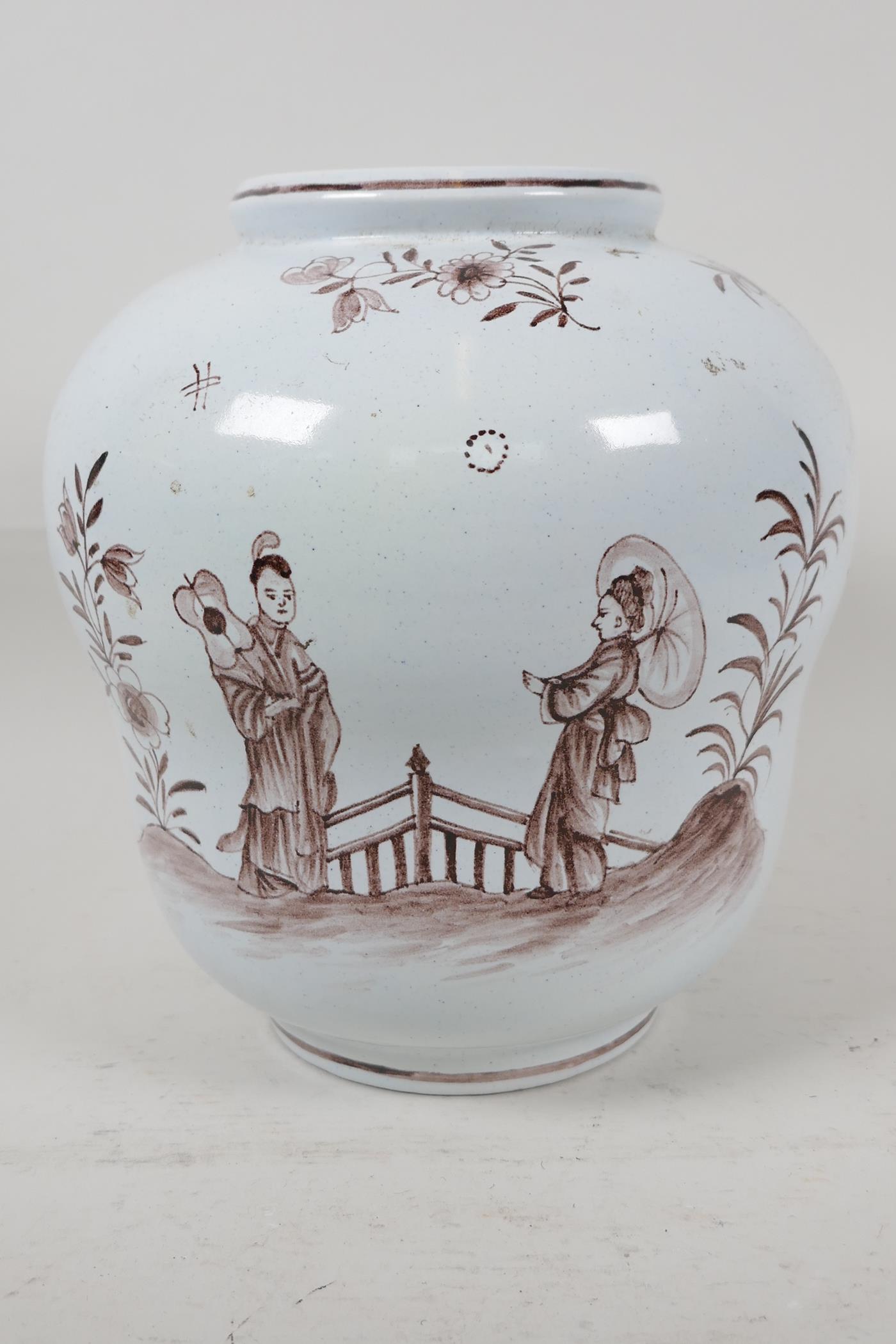 A C19th Delftware pottery vase painted with oriental figures in a garden, 8" high