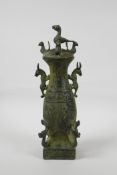 A Chinese archaic style bronze jar and cover, decorated with creatures of legend and character