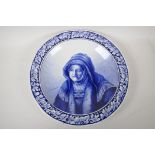 A Delft blue and white wall plaque painted with a portrait after Rembrandt, 15" high
