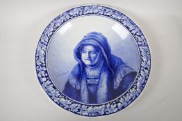 A Delft blue and white wall plaque painted with a portrait after Rembrandt, 15" high