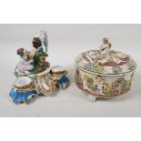 A C19th continental porcelain inkwell modelled as two children on a seesaw, 6" high, and a