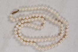 A string of 94 cultured pearls, 7mm diameter, on a 9ct gold clasp, with valuation from 2004)