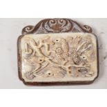 An oriental carved wood and bone pendant carved with birds in a flowering tree, 2½" long, signed