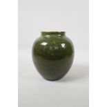 A Chhinese green speckle glazed pottery jar, 7" high