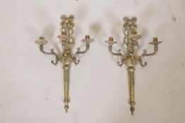 A pair of Empire style brass three branch wall sconces