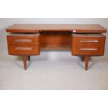 A 1970s G-Plan 'Fresco' teak dressing table/desk with floating top, lacks drawer, 60" x 18½", 27"