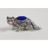 A sterling silver pincushion in the form of a fox set with ruby eyes, 1½" long