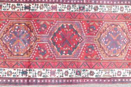 A full pile red ground hand woven Persian Heriz runner, small repair, 41" x 131"