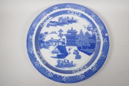 A Staffordshire blue and white charger decorated with the Long Bridge variation of the Willow