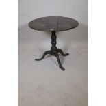 An C18th oak tilt top table raised on a turned column and tripod supports, (top fixed), 30" diameter