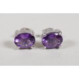 A pair of 925 silver and amethyst stud earrings