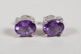 A pair of 925 silver and amethyst stud earrings