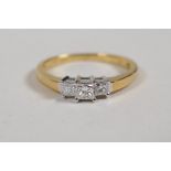 A 18ct yellow gold three stone diamond ring, size M