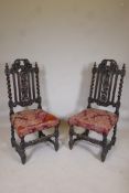 A pair of C19th oak Carolean style hall chairs with barleytwist columns and fruiting vine carved