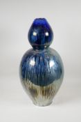 A vintage French blue lustre glazed terracotta double goured vase, stamped and indistinctly signed