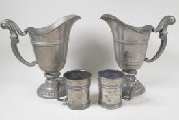 A pair of continental pewter ewers on pedestal bases, 9" high, and two antique half pint measures