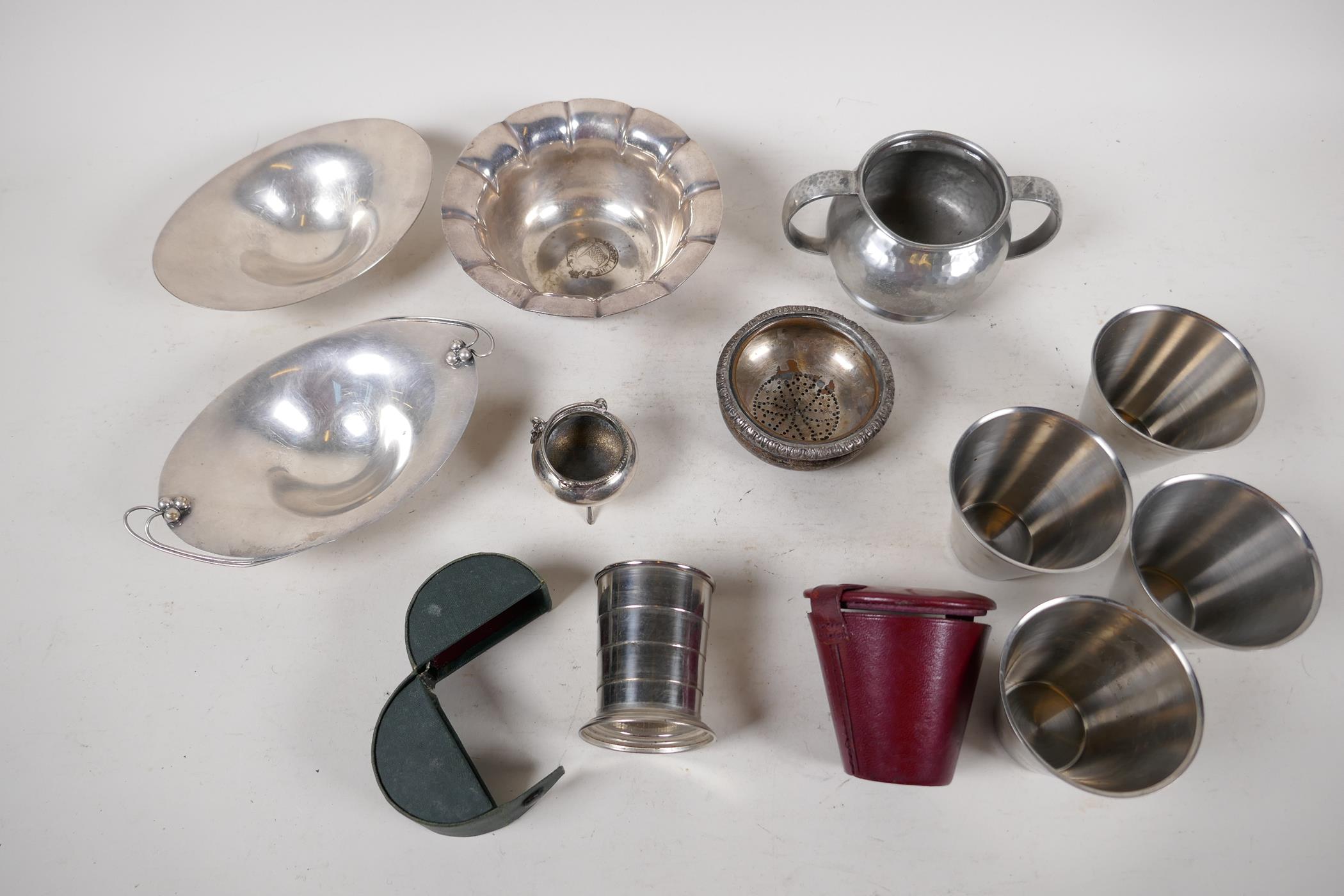 A small quantity of silver plated items to include two cased stirrup cups, a miniature caldron, a