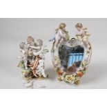 A German porcelain figure of cherubs embracing a young woman, together with a heart shaped