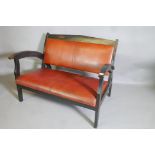 A mid century two seater settee with leather seat and back, A/F, 44" long