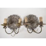 A pair of silver plated two light wall sconces decorated with a sunbird design, 7" diameter