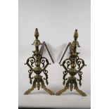 A pair of C19th French cast brass and iron fire dogs, 16½" high, 16" long