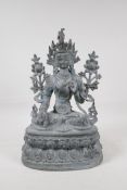 A Sino Tibetan bronze figure of a deity seated on a lotus throne, 15" high