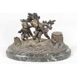A C19th French bronze desk inkstand cast as two boys in a woodland, on a marble base, 10" wide
