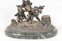 A C19th French bronze desk inkstand cast as two boys in a woodland, on a marble base, 10" wide