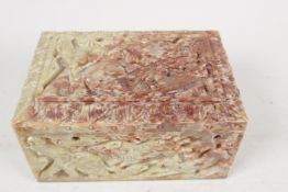 A carved soapstone table cigarette box carved with lions hunting elephants and deer, 6" x 4" x 3"