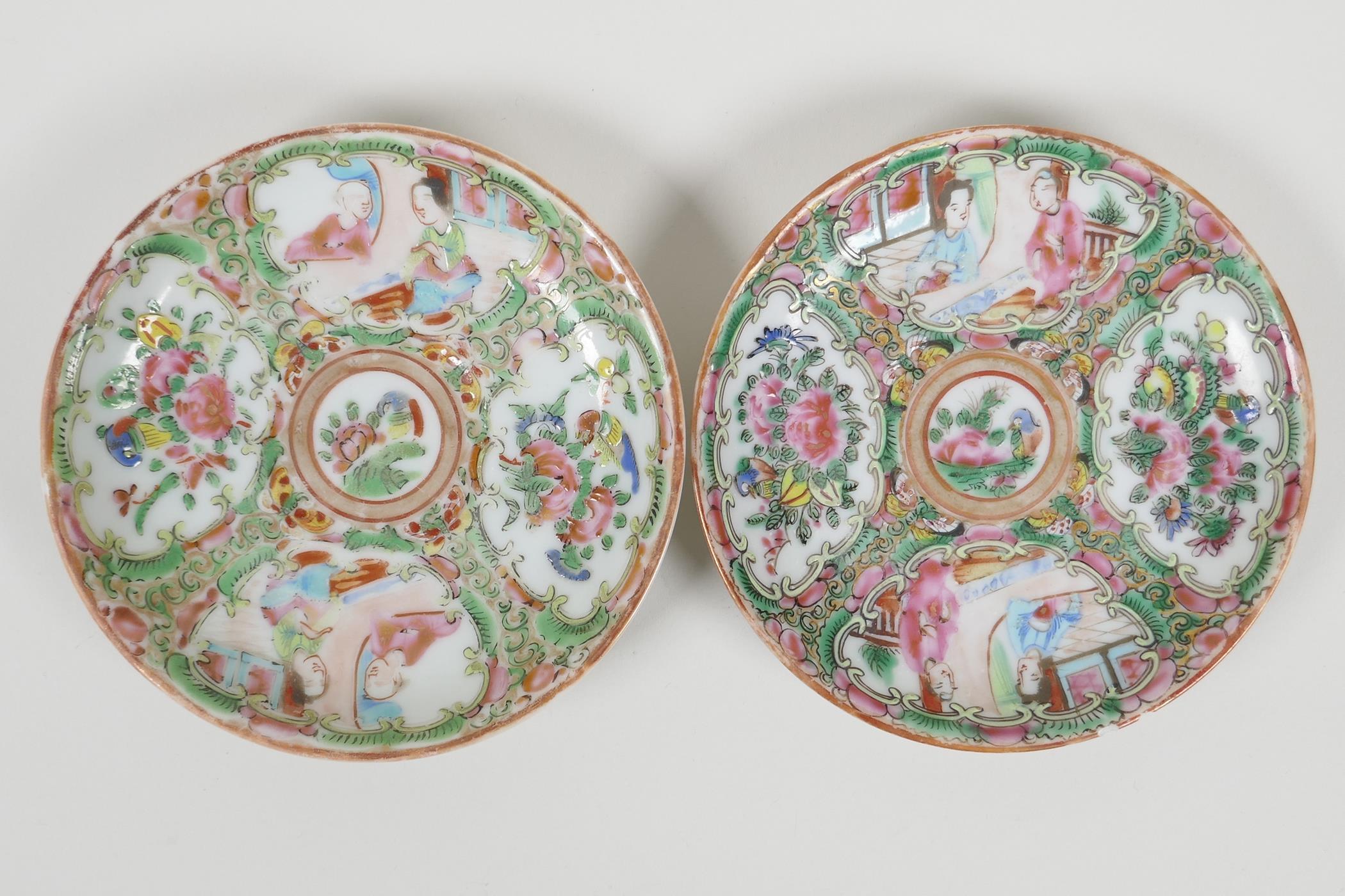 A pair of early C20th Canton famille rose saucers decorated with figures and flowers, 4½" diameter