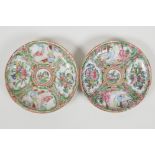 A pair of early C20th Canton famille rose saucers decorated with figures and flowers, 4½" diameter