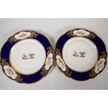 A pair of C19th Armorial porcelain plates decorated with two crest, a deer with rose and flag, and a