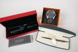 A Hugo Boss wristwatch with black dial and turquoise hands, a Ferrari fountain pen and a Cross