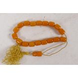 A string of butterscotch amber beads, each approx 10mm diameter, 19.5g total