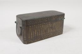 A C19th south east Asian silver inlaid bronze beetle nut box with three interior compartments,