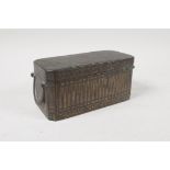 A C19th south east Asian silver inlaid bronze beetle nut box with three interior compartments,