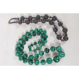 A single strand of 45 graduated malachite beads, 18mm to 7mm, 26" long, together with a C19th bead