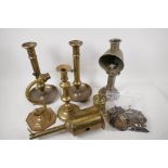 A quantity of brassware including a C19th meat jack, ejector candlesticks, drawer handles etc