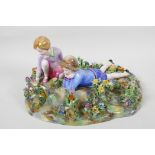 A mid C20th Crown Staffordshire figure, children in a bed of flowers, modelled by T. Bayley, 12"